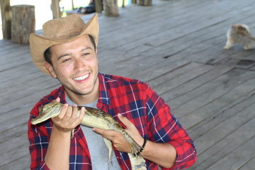 Human interacting with a baby caiman