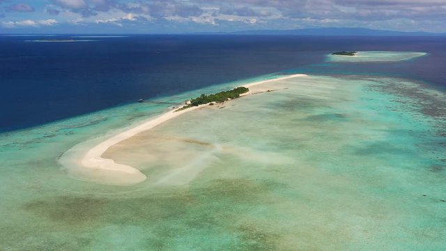 Aerial panoramic view of sandy islet Timba Timba, turquoise crystal clear waters of Celebes Sea, white sand beaches and coral reefs  - landscape panorama of Borneo island, Malaysia, Pacific Ocean