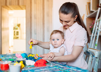 Mother and daughter playing with the kinetic sand.