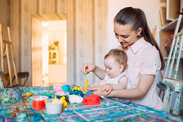 Mother and daughter playing with the kinetic sand.