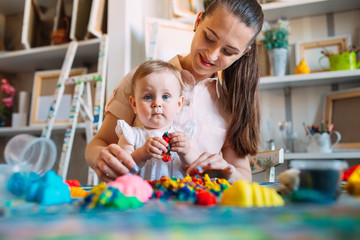 Mother and daughter playing with the kinetic sand.