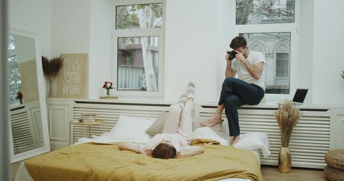 Pictures time in bedroom young couple taking photo for memories in bed , beautiful moments together.