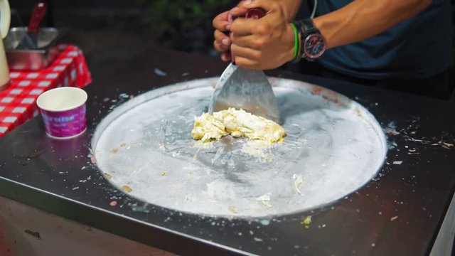 Slow motion preparing fruit ice cream on the night street market in Thailand