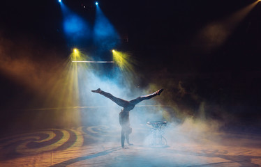 A man dancing in the circus arena.
