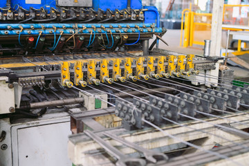 Steel wire metal feeding into bending machine in the industrial factory