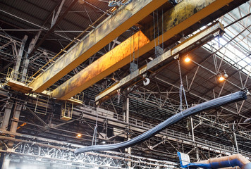 Crane loader carries rebar and wire rod in the factory.