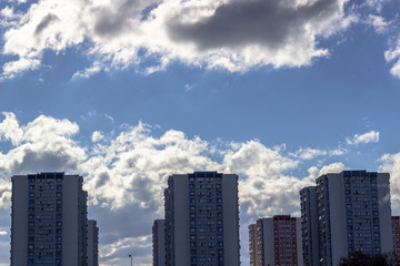 Wide clear shoot of array of concrete buildings with blue sky background