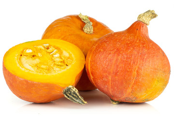 Group of two whole one half of raw fresh red kuri pumpkin hokkaido variety isolated on white...