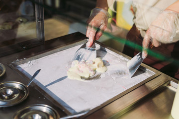 stir-fried ice cream rolls at freeze pan. Organic, natural rolled ice cream, hand made dessert.