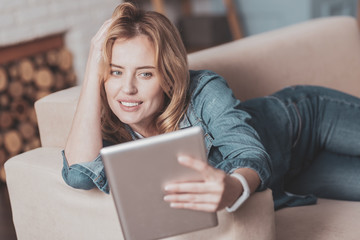 Attractive magnetic woman lying on the sofa