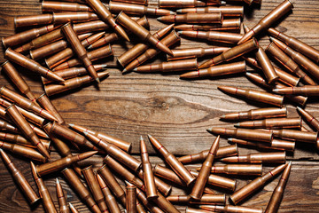 Bullets on wooden background.