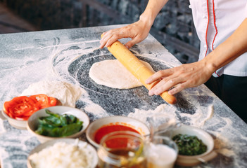 Cooking Pizza. Pizza ingredients on the  table.