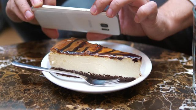 Man taking picture of tasty cheesecake in 4k slow motion 60fps