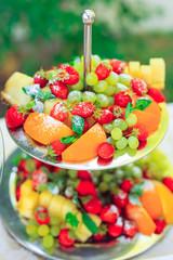 Tiered dish with cut fruits and grape