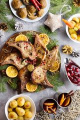 Fototapeta na wymiar Christmas dinner with roasted meat steak, Christmas Wreath salad, baked potato, grilled vegetables, cranberry sauce.