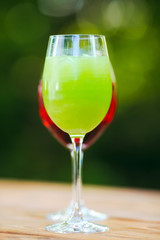 Summer cocktail. Fruit cocktail on green background. Citrus fruits, berries, strawberries, blueberries, mint, ice.