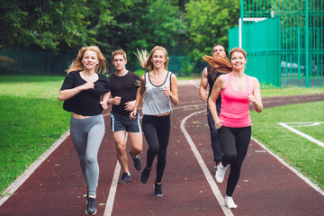 Professional runners running on a race track.