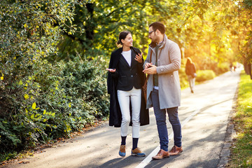 Fototapeta premium Businessman and businesswoman talking while going home after work