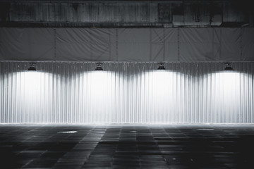 Light box with metal wall platform on with  spotlights,lamps hanging on wall background,Spotlight on empty wall.