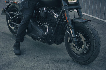 Obraz na płótnie Canvas Biker in black clothes sitting on motorcycle