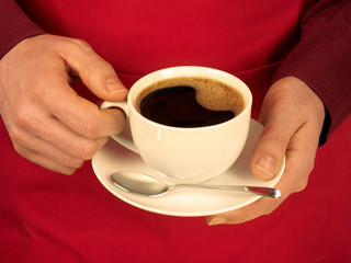 MAN HOLDING CUP OF ESPRESSO COFFEE