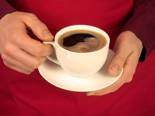 MAN HOLDING CUP OF BLACK COFFEE