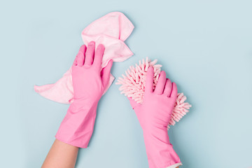 Female hands cleaning on blue background. Cleaning or housekeeping concept background. Copy space. ...