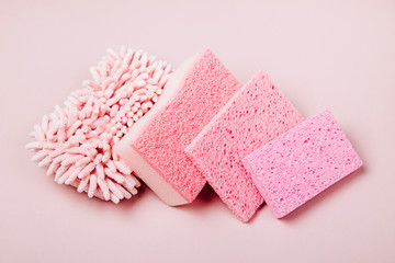 Sponges on pink background. Cleaning or housekeeping concept background. Copy space. Flat lay, Top view.