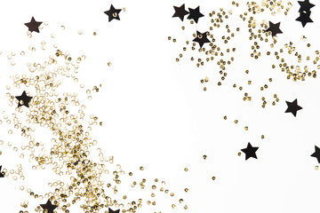 Background of golden confetti and black stars, holiday concept