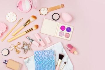 Female cosmetics collage with lipstick, brush and other accessories on pink background. Flat lay, top view.