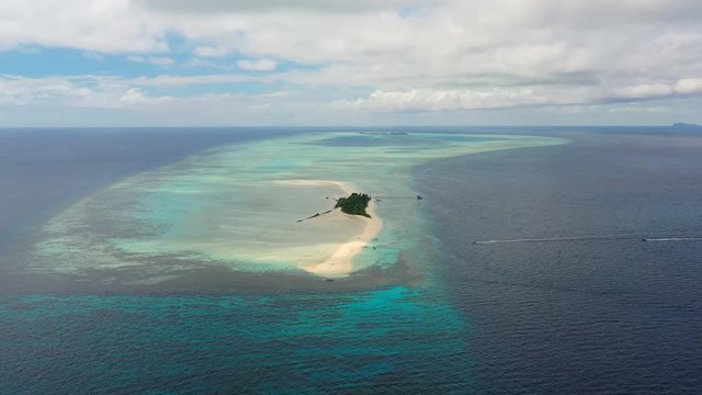 Aerial panoramic view of sandy islet Timba Timba, turquoise crystal clear waters of Celebes Sea, white sand beaches and coral reefs  - landscape panorama of Borneo island, Malaysia, Pacific Ocean