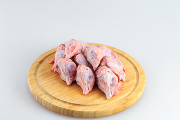 raw chicken heads on a white background