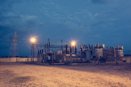 Electrical Power Substation Illuminated By Lights At Night.