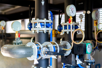 Closeup of manometer, measuring gas pressure. Pipes and valves at industrial plant. Pressure gauge,...