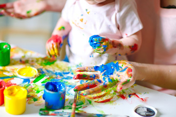 Mom and Daughter paint on canvas at the drawing school.