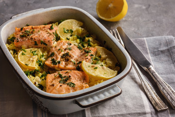 Salmon baked on oven with rice and lemon.