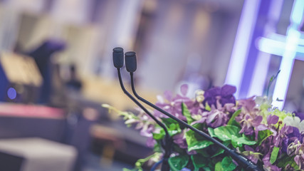 Microphone On Podium Stand Decorated With Fresh Colorful Flower Bunch