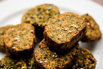 Cilantro cake or Kothimbir Vadi is a popular maharashtrian cuisine made with cilantro leaves. served with tomato ketchup. selective focus