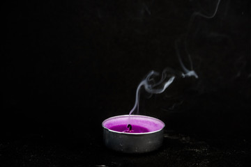 smoke from an extinguished candle on a black background
