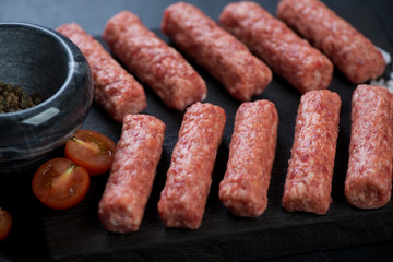 Closeup of fresh uncooked balkan cevapi or cevapcici sausages, selective focus