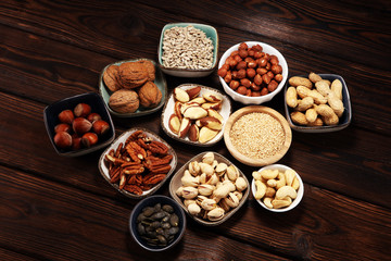 nuts composition on rustic table with walnut and peanut.