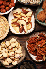 nuts composition on rustic table with walnut and peanut.