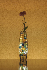 Vase in the dark. Romantic mood. Flower in a lighted vase