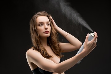 Young brunette in bra with hair spray shot