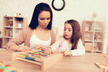 Girl and Woman Play Interesting Kids Game at Home.