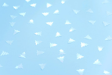 Colorful celebration background with party confetti on pastel blue background.