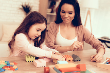 Fototapeta premium Mom and Daughter Play Educational Games at Home.