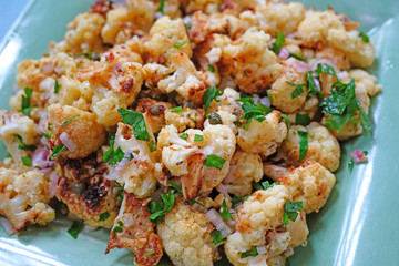Healthy salad of roasted cauliflower with parsley and onions