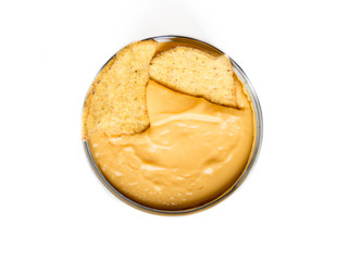 Close up of nachos in a tasty yellow cheddar cheese in a metallic cup, isolated on white. Nacho in cheddar.