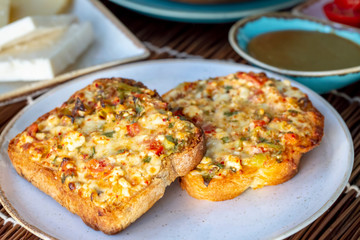 Delicious pastry, cheese with vegetables and bread slice.